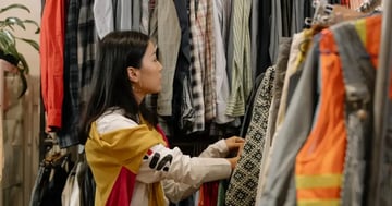 customer looking at clothes in a store