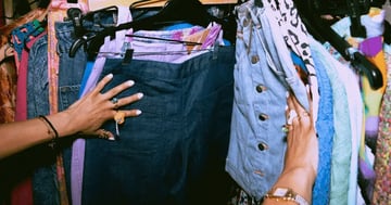 clothes on a rack in thrift store