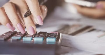 Woman using calculator