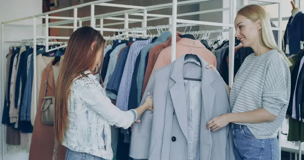 Worker helping a woman at a thrift store